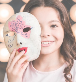 close up girl holding venetian mask front her face