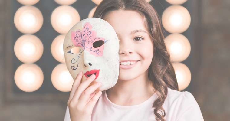 close up girl holding venetian mask front her face